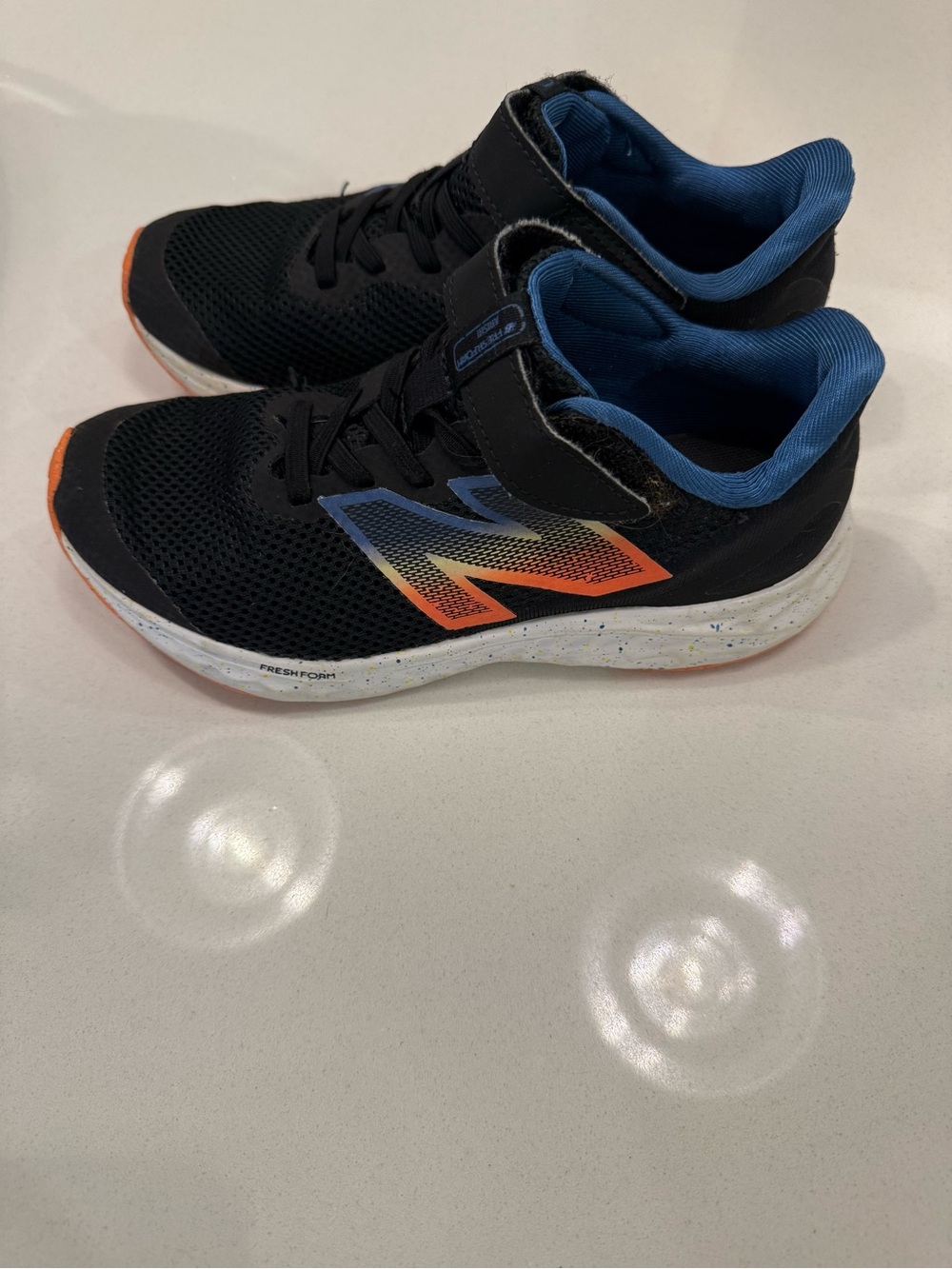 New Balance Kids Black Sneakers with Blue & Orange Accents